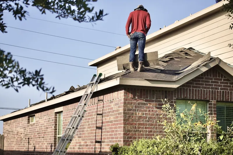 Professional roofer working on a residential roof in Heritage Farms